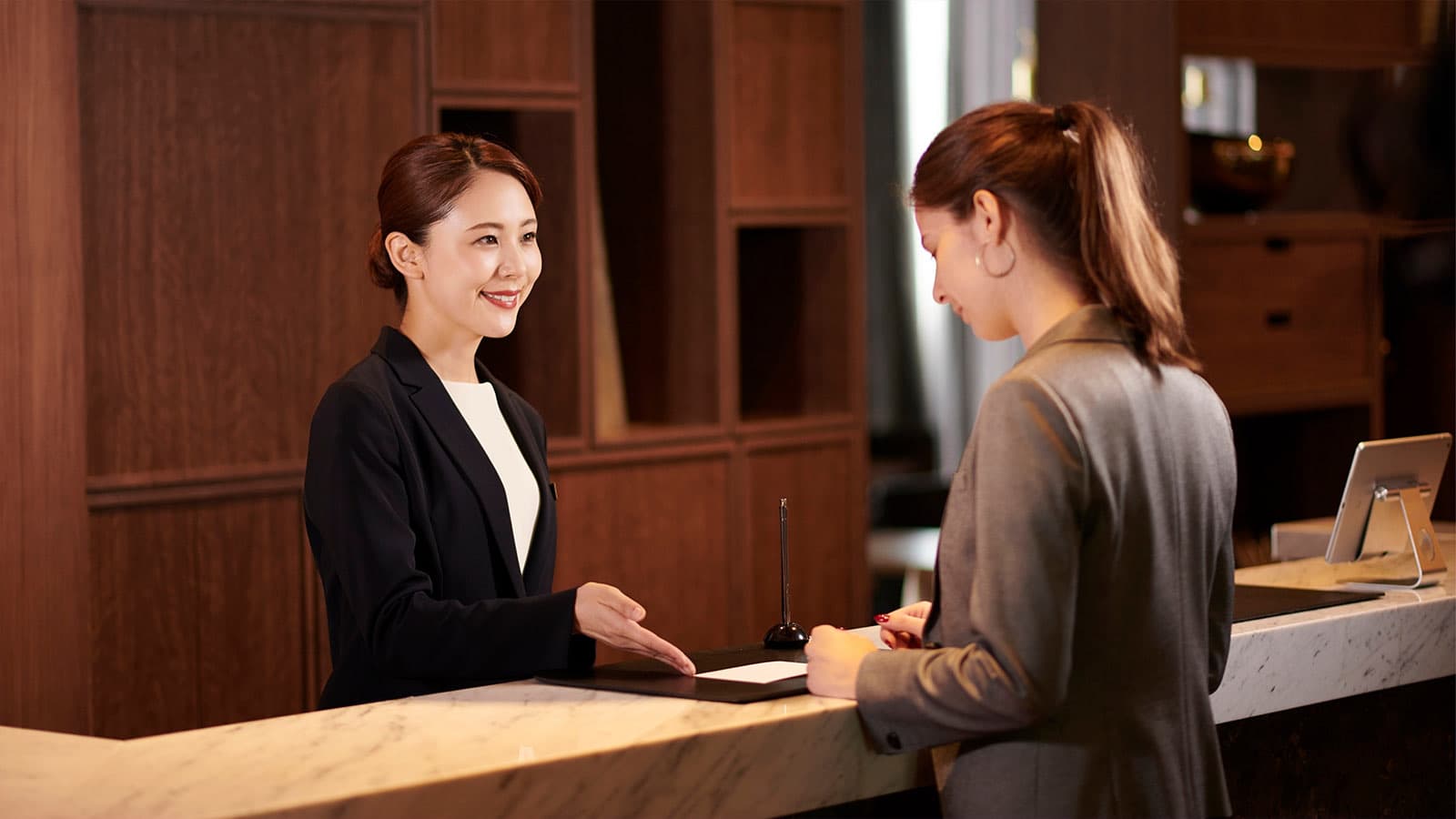 Hospitality booking site on a coral gradient